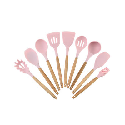Le silicone antiadhésif faisant cuire l'ustensile de couleur a placé la trousse d'outils de cuisine